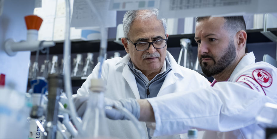 Dr. Kamel Khalili and a researcher collaborating on HIV research in a lab