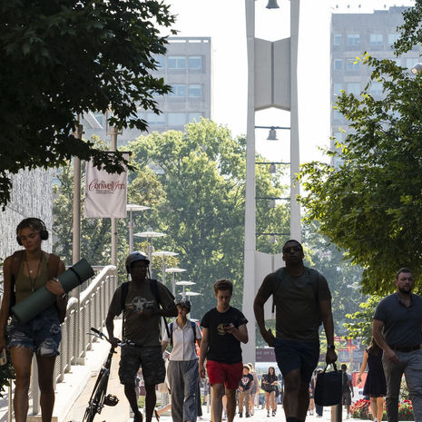 Students walking with the Bell Tower in the background