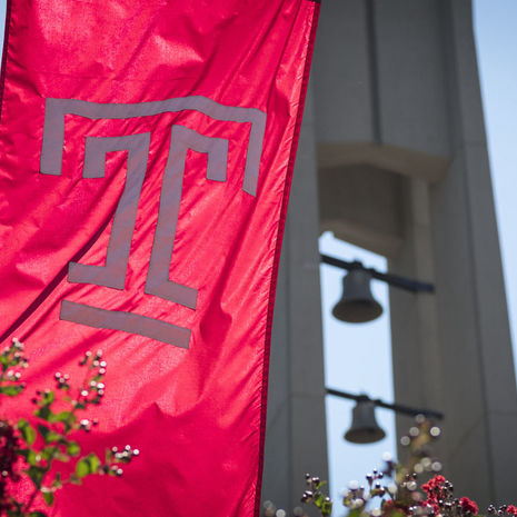 Image of a Temple logo flag on campus. 