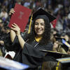 Graduating student holding up Commencment program