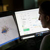 Person viewing scatter plot on computer screen