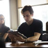 student using tablet in conference room