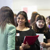 Student at Job Fair holding folder of papers