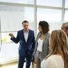 Four Katz School of Medicine Faculty Members discussing in front of a projector screen