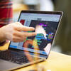 Hand pointing to schedule on computer