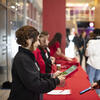 Staff scanning a prospective student's phone for event registration