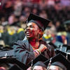 Student standing at commencement in cap and gown