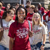 Students processing to Convocation in red and white t shirts