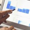 Person pointing to analytical data on a computer screen
