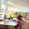 Students discussing around table in library